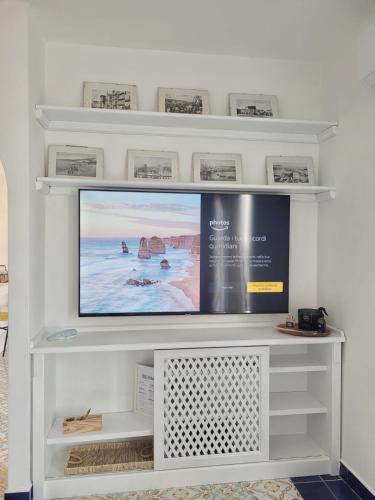 a flat screen tv sitting on a white entertainment center at La Terrazza sul Faro in Porto Empedocle