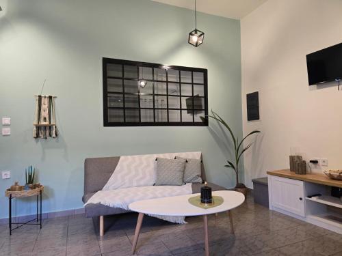 a living room with a couch and a table at Filoxenia house in Kremasti