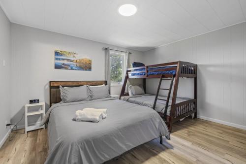 a bedroom with two bunk beds and a window at Beautiful Torch Lake House with Beach Access home in Rapid City