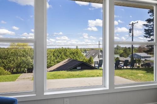 a window view of a yard from a house at Beautiful Torch Lake House with Beach Access home in Rapid City