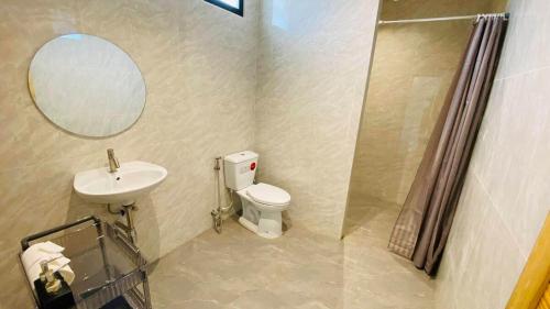 a bathroom with a sink and a toilet and a mirror at Private Sanctuary Yanui beach in Nai Harn Beach