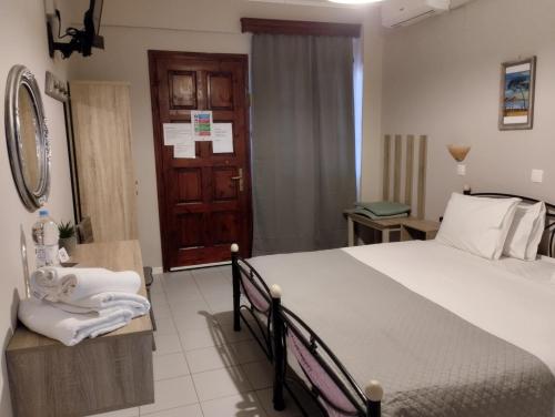 a bedroom with a large bed and a bathroom at Miramare in Petra