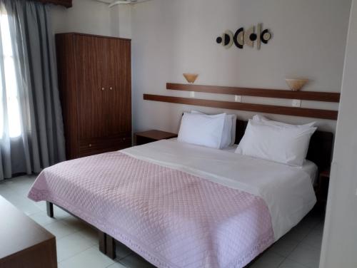 a bedroom with a large bed with white sheets and pillows at Miramare in Petra