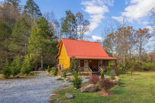 a small yellow cabin with an orange roof at Creekside with views - jacuzzi firepit arcade in Cosby