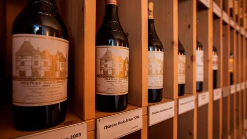 a row of bottles of wine on a shelf at Parkhotel Delta, Wellbeing Resort in Ascona