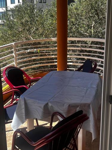a table and chairs sitting on a porch with a table and chairs at Better place in Becici