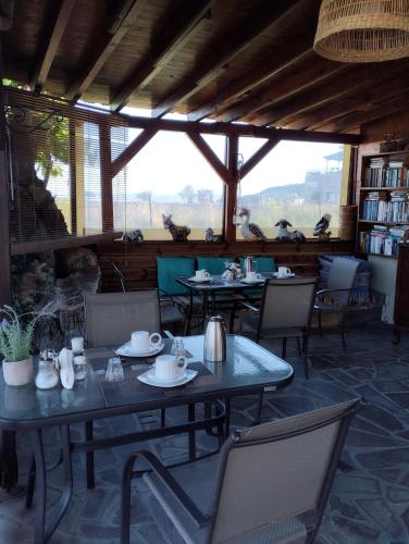 a dining room with tables and chairs with birds on them at Miramare in Petra