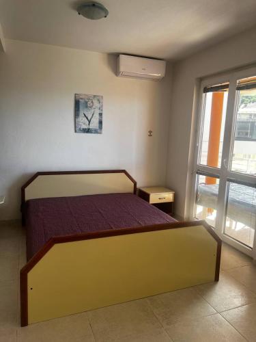 a bedroom with a bed and a clock on the wall at Better place in Becici