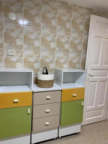 a kitchen with colorful drawers and a door at La Remus in Moieciu de Jos