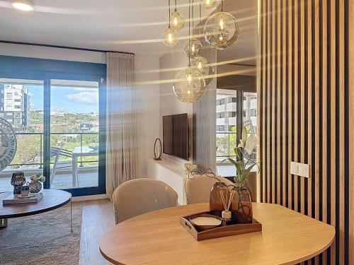 a dining room with a table and a tv at Hanami Luxury Apartment Connecta in Estepona