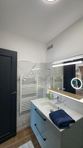 a bathroom with a sink and a mirror at Coup de cœur BB in Cogolin