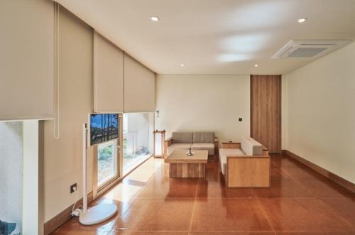 a living room with a couch and a table at IJE Gyeongju in Gyeongju