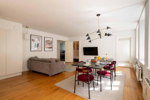 a living room with a table and chairs and a couch at Perfect 3 bedroom apartment in the heart of CPH in Copenhagen