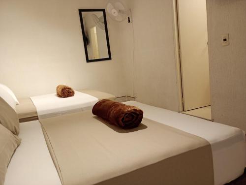 two croissants sitting on a bed in a room at Hotel Aerocafe Pereira in Pereira