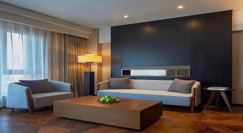 a living room with a couch and a coffee table at NH Shijiazhuang Financial Center in Shijiazhuang