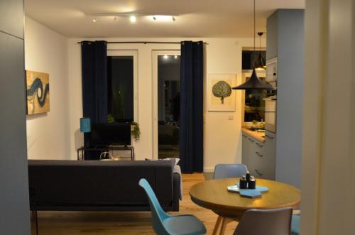 a living room with a couch and a table at MSF Apartment Green Wolf in Kassel