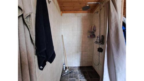 a small bathroom with a shower with a tiled floor at Messlingen 310 in Funäsdalen