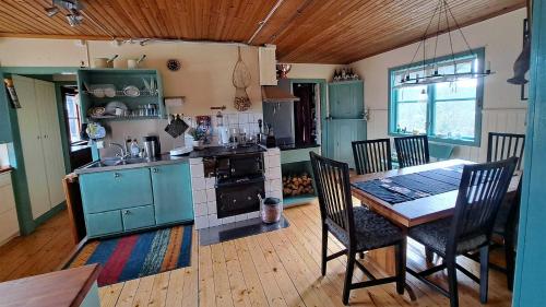 a kitchen with a table and chairs in a room at Messlingen 310 in Funäsdalen