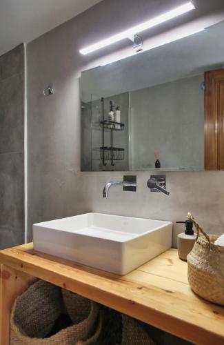 a bathroom with a white sink and a mirror at Villa Thea sitia in Sitia