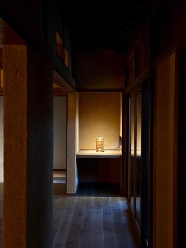 an empty room with a candle on a table at 囲み宿 こわね in Tonosho