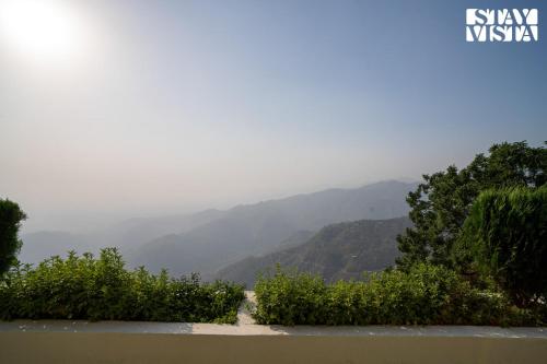 a view of a valley with mountains in the background at StayVista at Echoes of Ease with Bonfire & WiFi in Rishīkesh