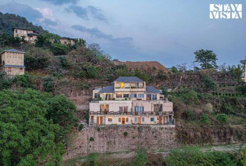 a house on the side of a mountain at StayVista at Echoes of Ease with Bonfire & WiFi in Rishīkesh