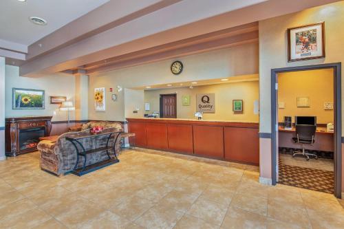 a large lobby with a waiting room and a waiting room at Quality Inn & Suites in Lethbridge