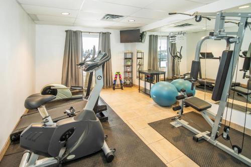 a gym with tread machines and exercise bikes in a room at Quality Inn & Suites in Lethbridge