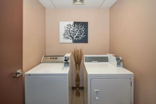 a laundry room with a washer and dryer at Quality Inn & Suites in Lethbridge