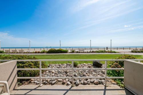 a view of the beach from the balcony of a house at Country Inn & Suites by Radisson, Virginia Beach Oceanfront , VA in Virginia Beach