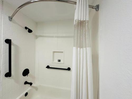 a shower with a white shower curtain in a bathroom at Country Inn & Suites by Radisson, Canton near Hall of Fame in Canton
