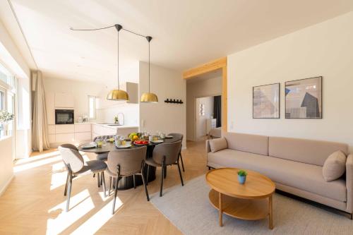 a living room and kitchen with a couch and a table at Newly Renovated 2BR with Balcony in Copenhagen