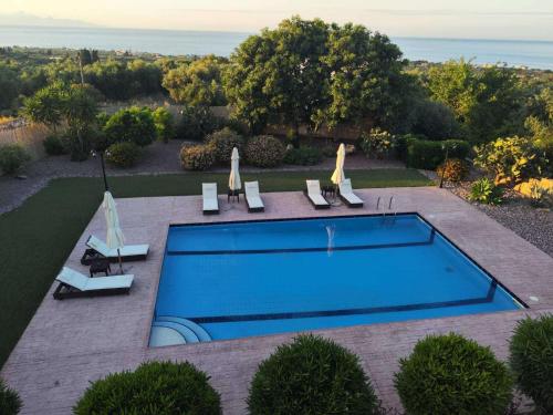 an overhead view of a swimming pool in a yard at Villa Hestia - Seaview Serenity Villa with Private Pool by Villa Mana Gers in Kipseli