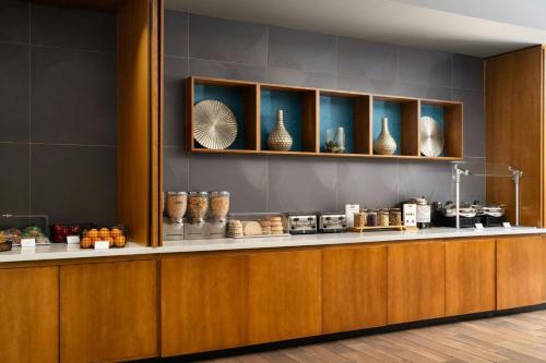 a lobby with a counter with vases on it at SpringHill Suites by Marriott Charleston Mount Pleasant in Charleston