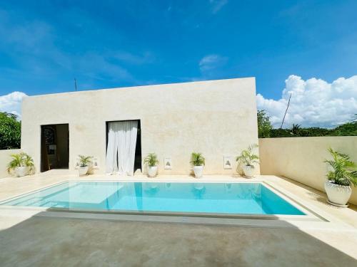 a swimming pool in the backyard of a house at Tulia House Lamu in Lamu