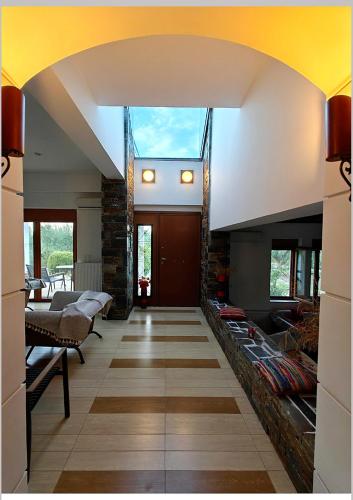 a living room with a large window in the ceiling at Beach Villa Claire in Loukísia