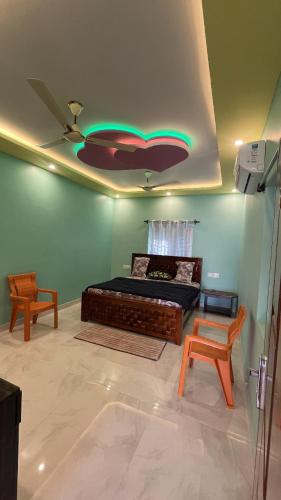 a bedroom with a bed and a ceiling fan at Rest & Relax Resort in Yelagiri