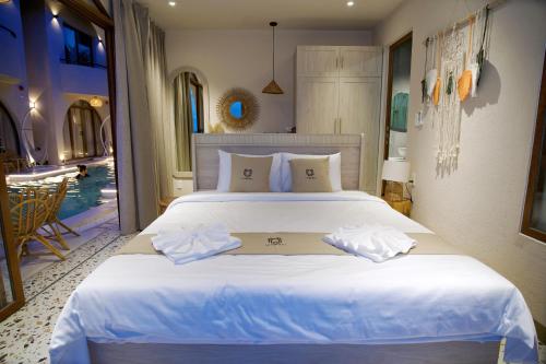 a bedroom with a large bed and a swimming pool at La Mer Bali Mui Ne in Phan Thiet