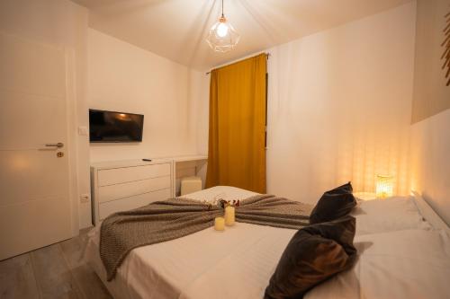 a bedroom with a bed with two teddy bears on it at Pool and Breakfast Apartments Villa Maro in Novalja