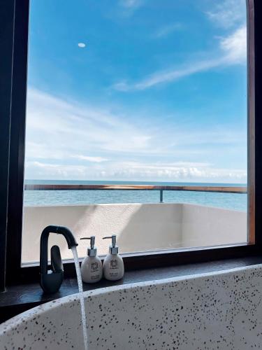 a bathroom sink with a view of the ocean at La Mer Bali Mui Ne in Phan Thiet