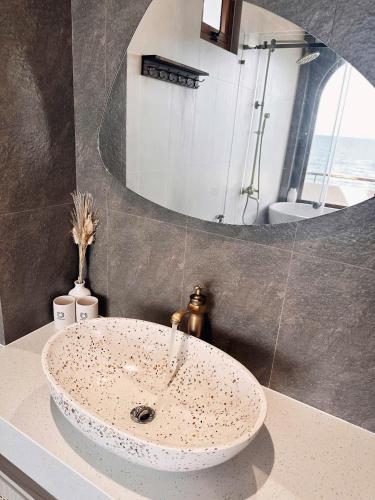 a bathroom with a sink and a mirror at La Mer Bali Mui Ne in Phan Thiet