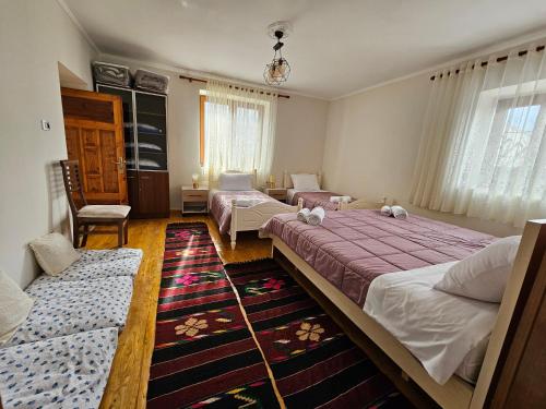 a bedroom with two beds and a living room at Bujtina Goleci in Rabdisht