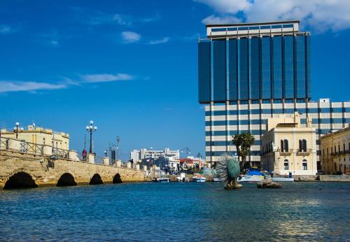 a bridge over a body of water with a building at Hotel Bellavista Club-Caroli Hotels in Gallipoli