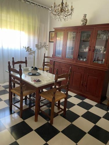 a dining room with a table and chairs and a chandelier at La Casa dei Nonni in Bracciano