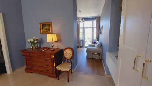 a room with a dresser and a chair with a lamp at Castle View in Budapest