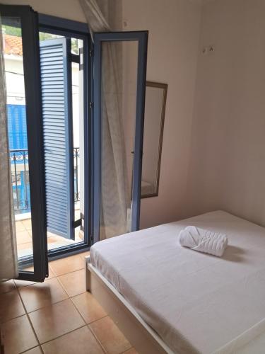 a bedroom with a bed and a large window at Agia Effimia RIVIERA APPARTMENT in Agia Effimia