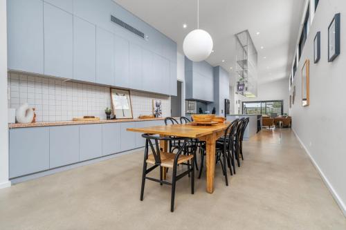 a dining room with a wooden table and chairs at Allure - stunning in central Port Fairy in Port Fairy