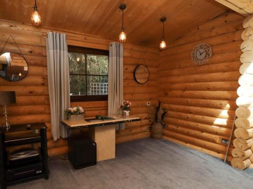 a room with a desk in a log cabin at Starwood in Morpeth