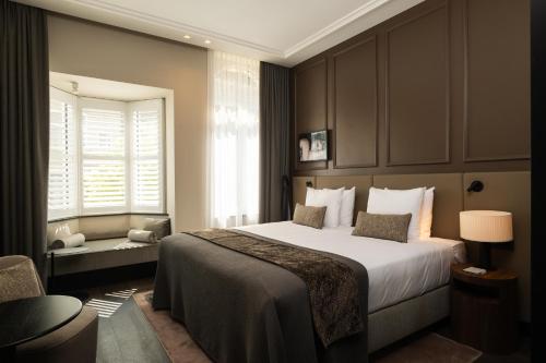 Postel nebo postele na pokoji v ubytování Boutique Hotel Beaumont Maastricht