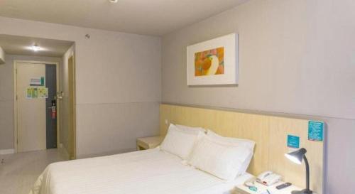 a hotel room with a bed and a telephone at JinJiang Inn Nanjing The Confucius Temple Zhonghuamen Metro Station in Nanjing